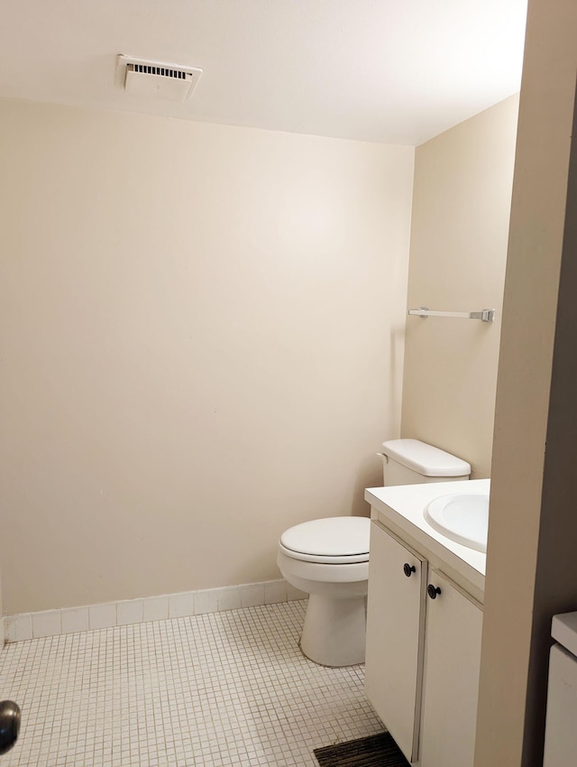 bathroom with tile patterned floors, vanity, and toilet