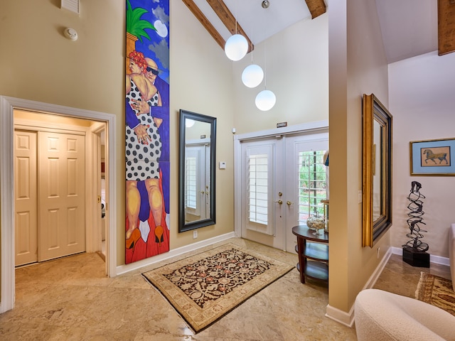 entrance foyer featuring high vaulted ceiling, french doors, and beam ceiling