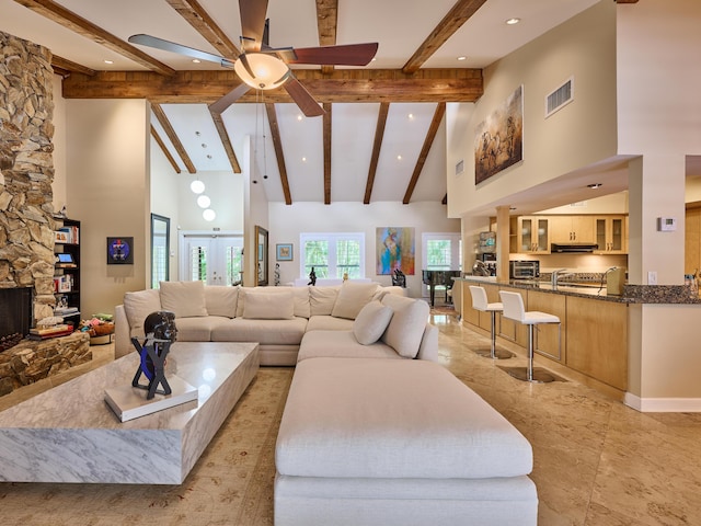 18238 128th Trl N, Jupiter, FL 33478 - living room featuring high vaulted ceiling, ceiling fan, beamed ceiling, recessed lighting, and a stone fireplace