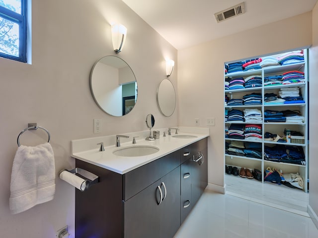 18238 128th Trl N, Jupiter, FL 33478 - full bath featuring tile patterned flooring, double vanity, a walk in closet, and baseboards