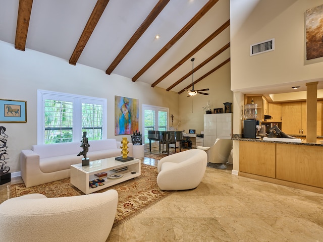 living room with ceiling fan, high vaulted ceiling, and beam ceiling