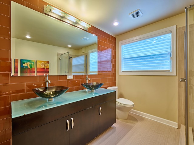 18238 128th Trl N, Jupiter, FL 33478 - bathroom with a shower stall, double vanity, toilet, tasteful backsplash, and baseboards