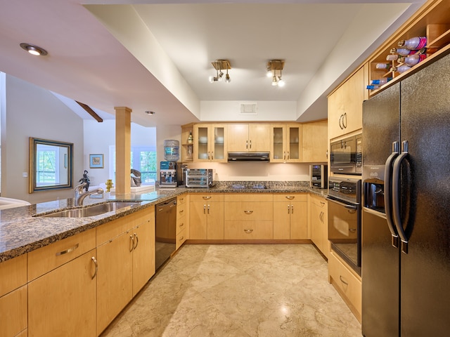 kitchen featuring kitchen peninsula, sink, black appliances, dark stone counters, and light brown cabinets