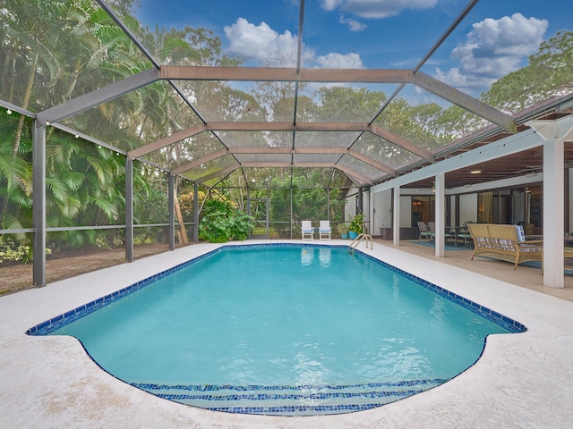 view of swimming pool featuring a lanai and a patio area