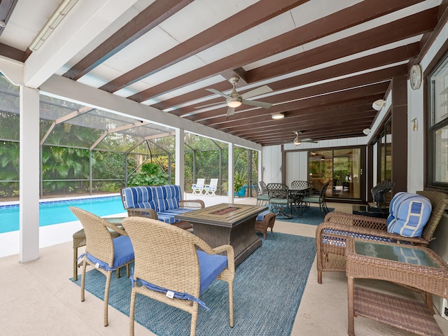 view of patio / terrace with ceiling fan and an outdoor living space with a fire pit