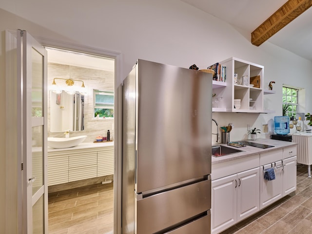 18238 128th Trl N, Jupiter, FL 33478 - kitchen featuring freestanding refrigerator, a sink, beamed ceiling, white cabinetry, and wood tiled floors