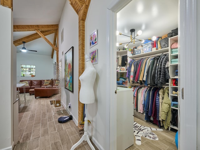 18238 128th Trl N, Jupiter, FL 33478 - walk in closet with wood tiled floors, a ceiling fan, and a chandelier