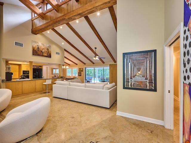 18238 128th Trl N, Jupiter, FL 33478 - living room with high vaulted ceiling, beamed ceiling, recessed lighting, baseboards, and a skylight