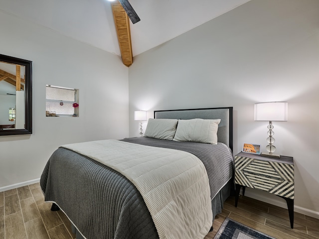 bedroom with ceiling fan and lofted ceiling with beams