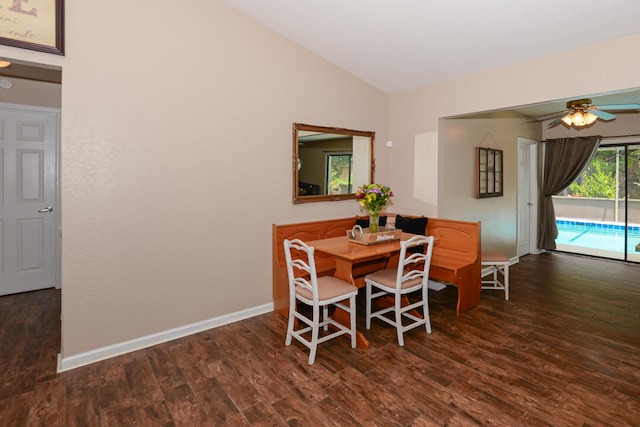 dining area featuring vaulted ceiling, ceiling fan, and dark hardwood / wood-style flooring