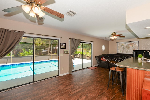 kitchen featuring dark hardwood / wood-style floors, a breakfast bar, and sink