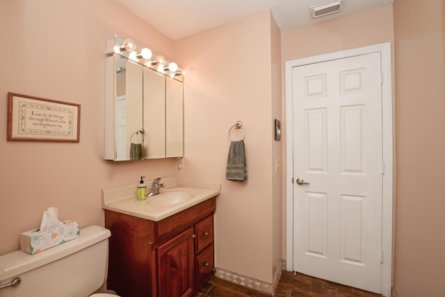 bathroom with toilet and vanity