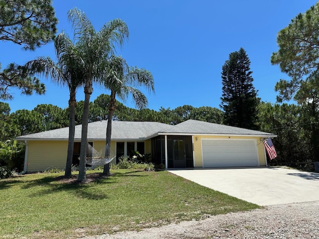 ranch-style home with a garage and a front lawn