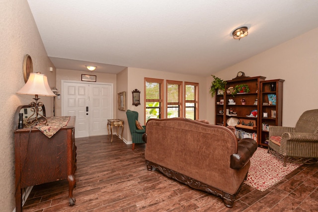 living room featuring vaulted ceiling and dark hardwood / wood-style flooring