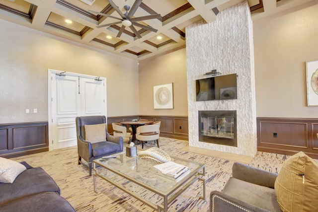 living room with a fireplace, beamed ceiling, and coffered ceiling