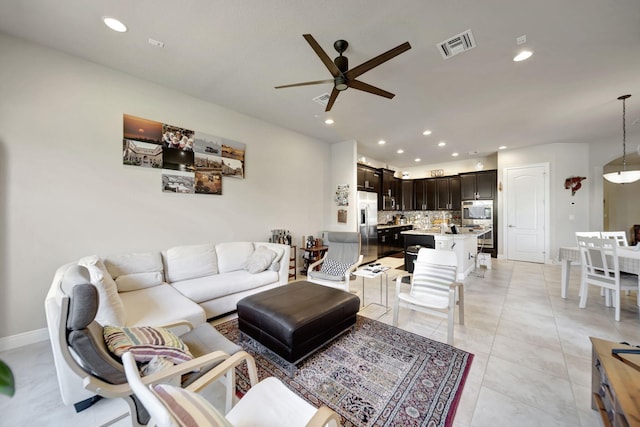 tiled living room featuring ceiling fan