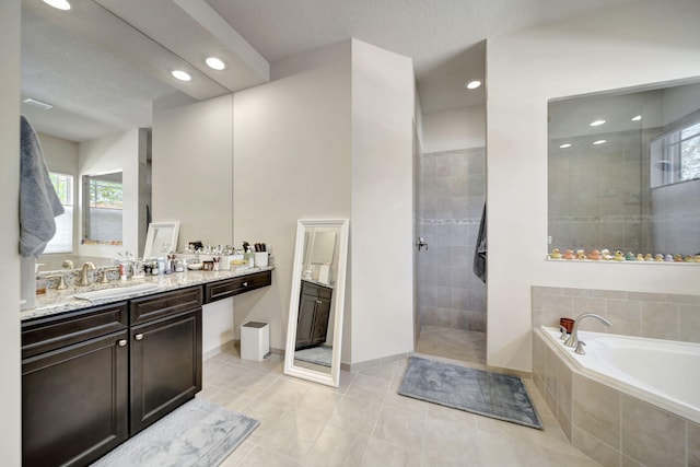 bathroom featuring vanity, a textured ceiling, tile patterned floors, and independent shower and bath