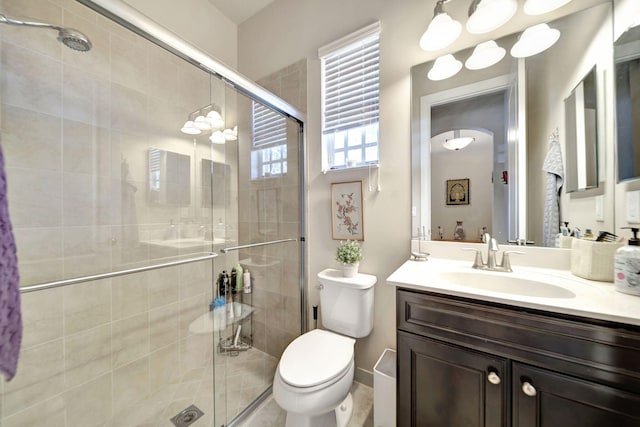 bathroom with vanity, toilet, and an enclosed shower