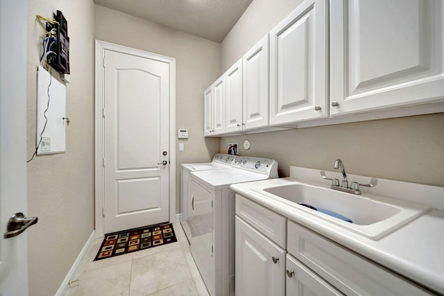 washroom with cabinets, sink, a textured ceiling, light tile patterned floors, and washing machine and dryer