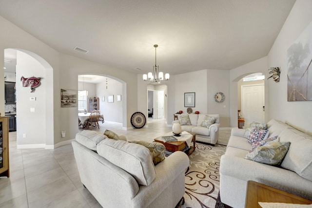 tiled living room with a chandelier