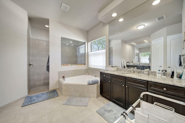 bathroom with a wealth of natural light, tile patterned flooring, vanity, and separate shower and tub