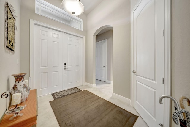 foyer entrance with light tile patterned floors