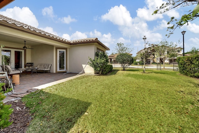 view of yard with an outdoor hangout area, ceiling fan, and a patio area