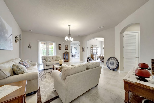 living room with a chandelier and light tile patterned floors