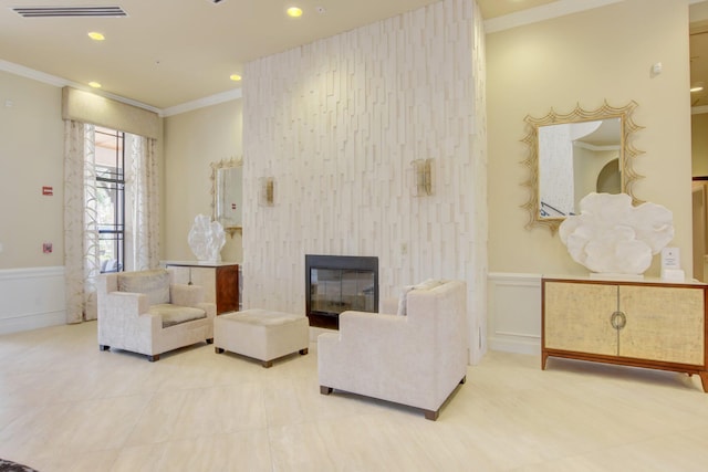 living room with a fireplace and crown molding