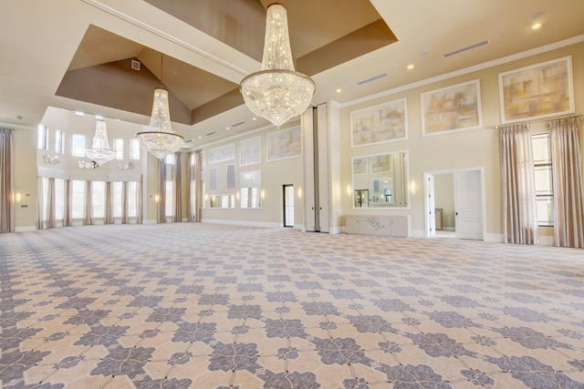 unfurnished living room with a towering ceiling, carpet floors, and crown molding