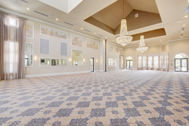 interior space featuring ornamental molding, a towering ceiling, and an inviting chandelier