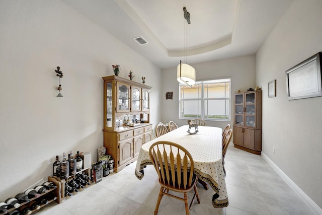 dining area with a tray ceiling