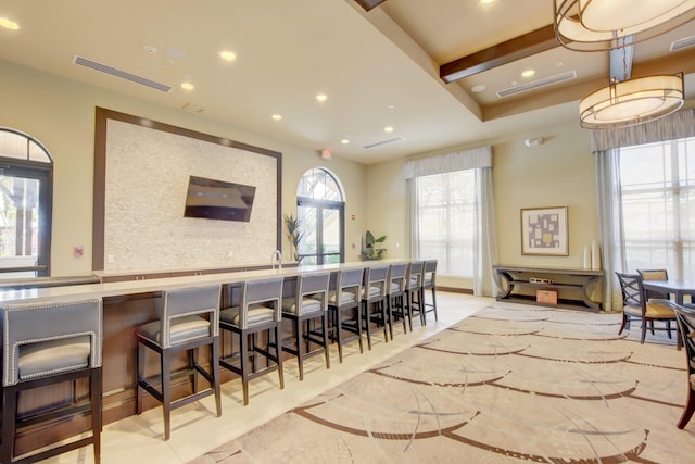 kitchen with beamed ceiling and a breakfast bar area