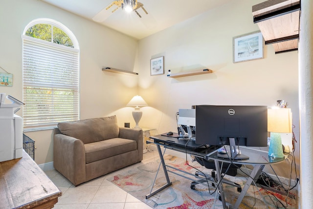 tiled office space featuring ceiling fan