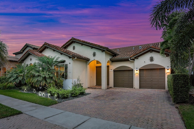 mediterranean / spanish-style home with a garage