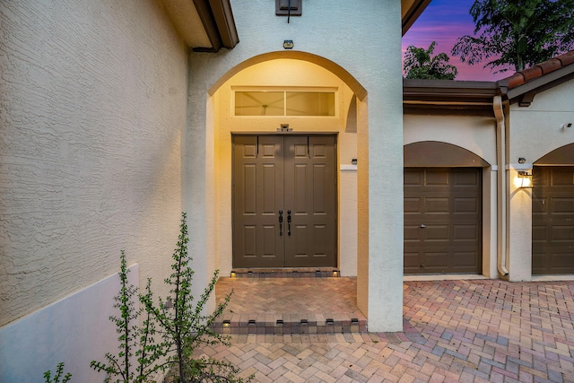 view of exterior entry at dusk