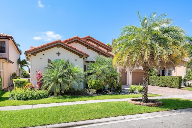 mediterranean / spanish home with a front yard