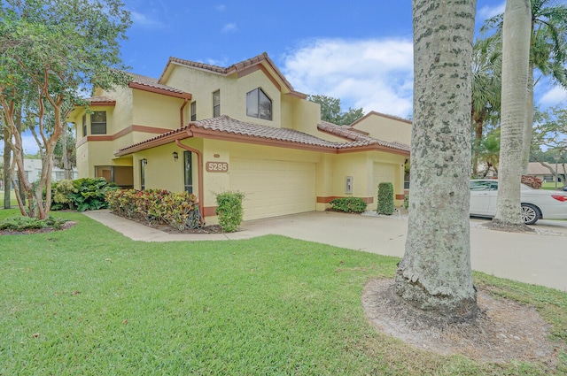 mediterranean / spanish home with a garage and a front yard