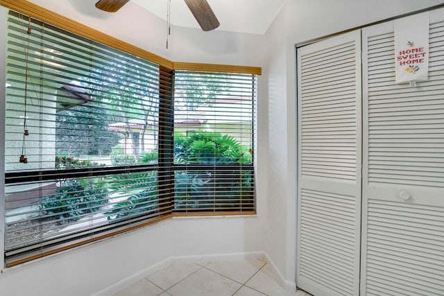 interior space with tile floors and ceiling fan