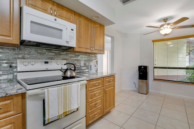 kitchen featuring backsplash, ceiling fan, white appliances, and light tile floors