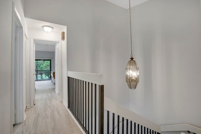 hallway with light hardwood / wood-style floors