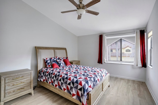 bedroom with vaulted ceiling, ceiling fan, and hardwood / wood-style flooring