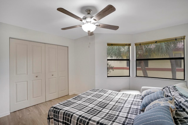 bedroom featuring a closet, ceiling fan, and light hardwood / wood-style flooring