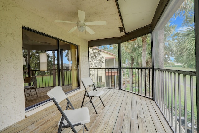 sunroom / solarium featuring ceiling fan