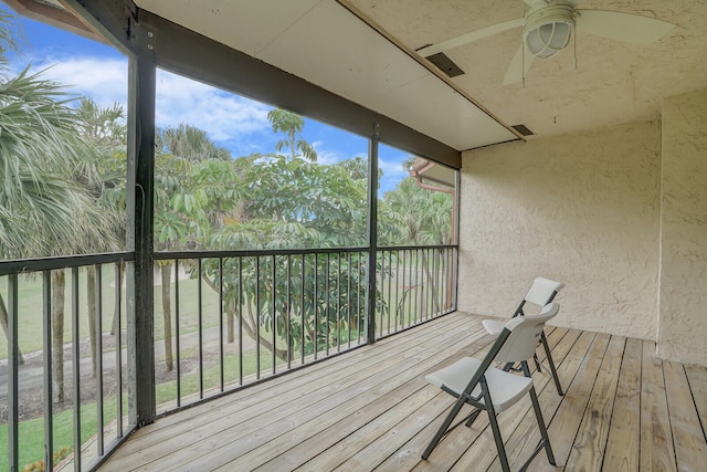 unfurnished sunroom featuring plenty of natural light and ceiling fan