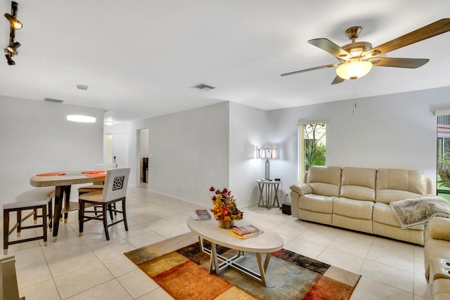 living room featuring ceiling fan, light tile floors, and rail lighting