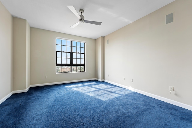 carpeted empty room featuring ceiling fan