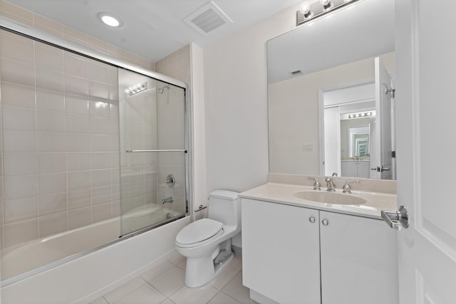 full bathroom with tile patterned floors, vanity, enclosed tub / shower combo, and toilet