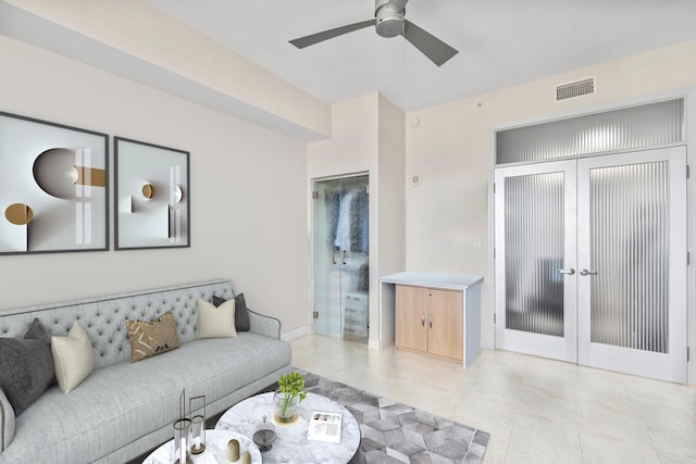 living room featuring ceiling fan and french doors