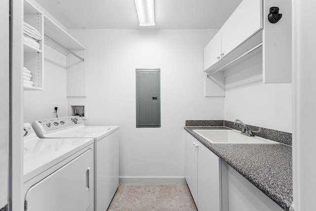 clothes washing area featuring sink, cabinets, washing machine and dryer, and electric panel